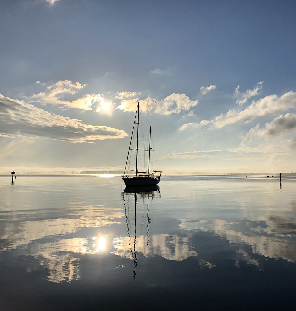 Flat calm water reflecting wispy clouds in St. Michaels, MD